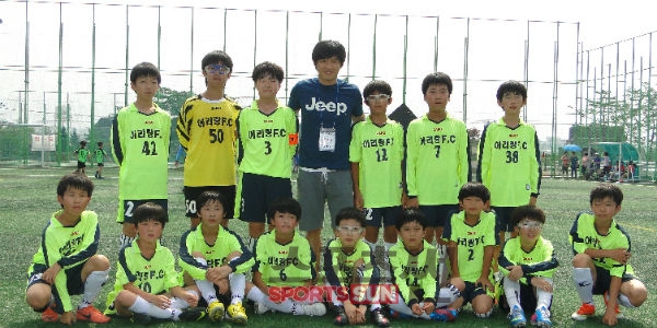 <사진설명> 2013년 전국 유소년축구대회에서 입상한 " 아리랑 FC " 팀이 김광진 코치와 기념촬영을 하고 있다.
